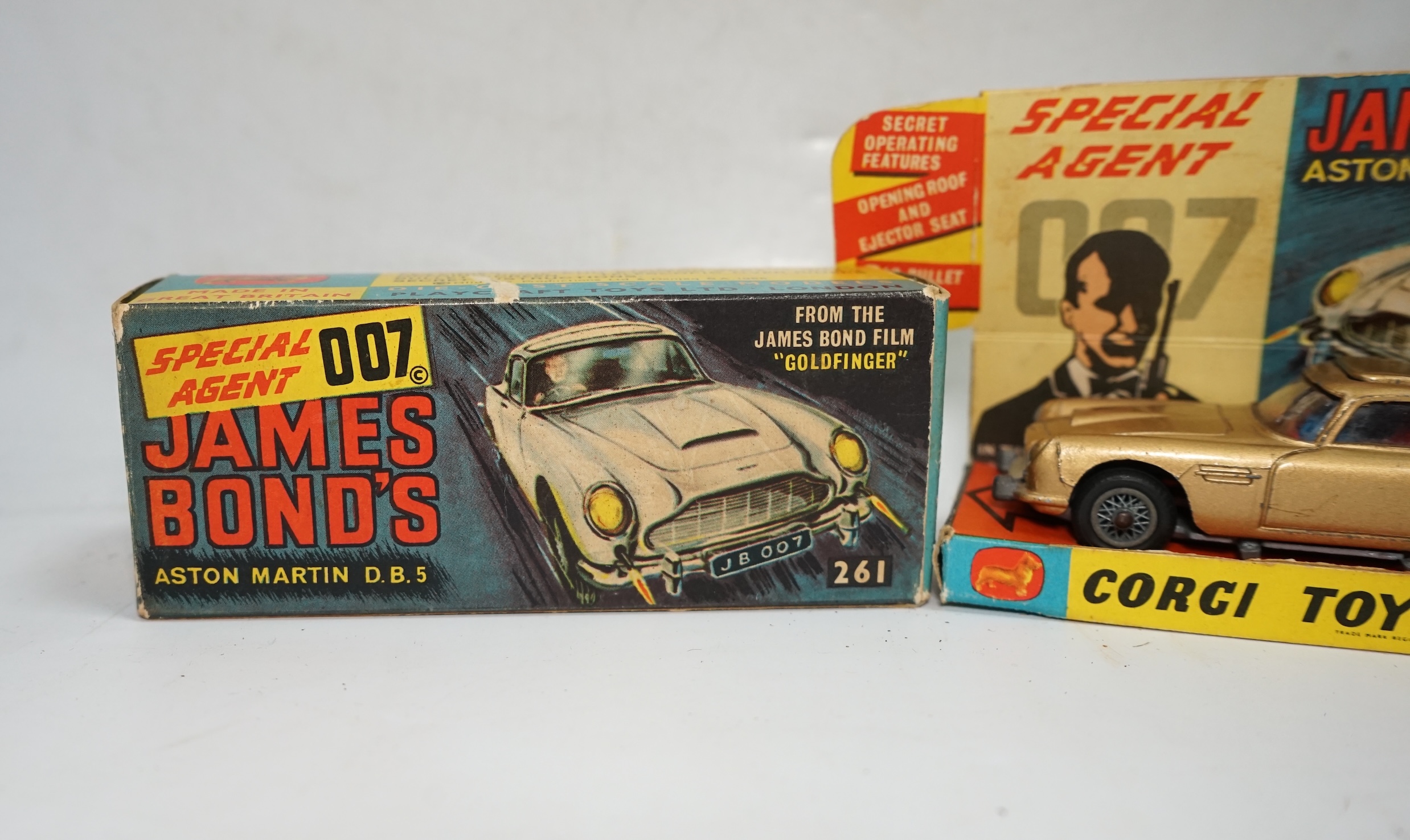 A boxed Corgi Toys James Bond 007 Aston Martin DB5 (261), a gold Aston Martin, with inner display stand, the envelope for the secret instructions (contents missing), the correct James Bond advertising leaflet and two pas